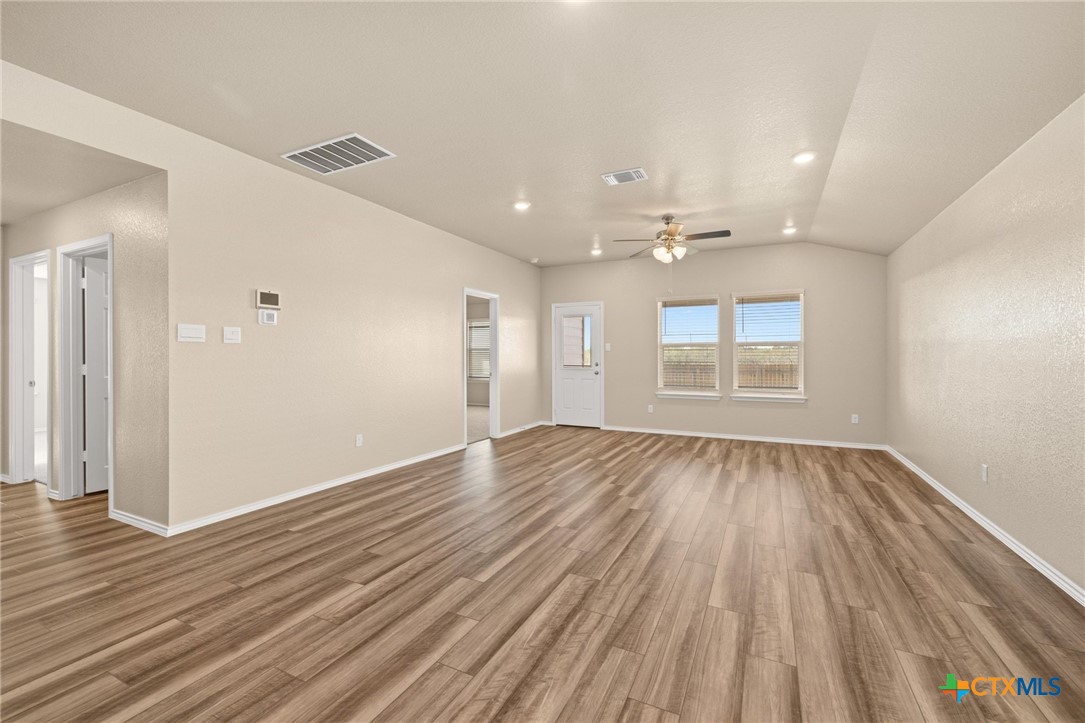 922 Stone Vly Road Temple, TX 76502 - Photo 6 of 32 an empty room with wooden floor and windows