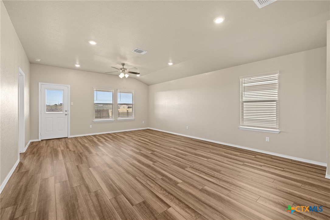 922 Stone Vly Road Temple, TX 76502 - Photo 7 of 32 wooden floor in an empty room with a window