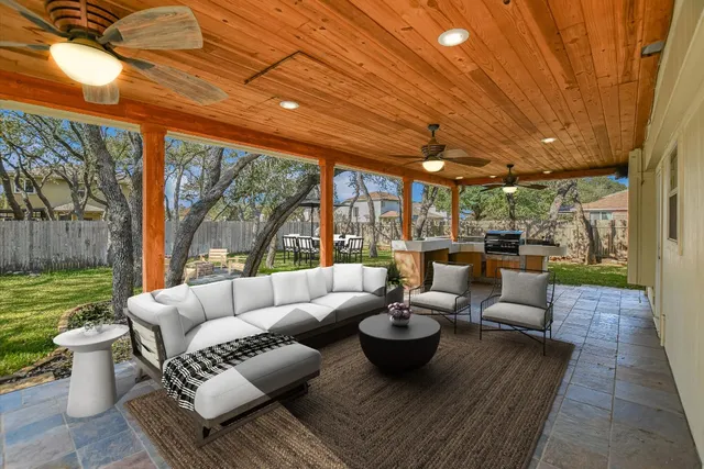 a living room with patio furniture and a garden