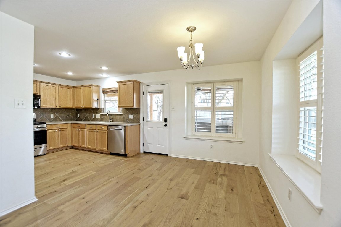 3462 Flowstone Lane Round Rock, TX 78681 - Photo 11 of 33 a view of a kitchen with a sink wooden floor and a kitchen
