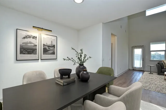 a dining room with furniture and wooden floor