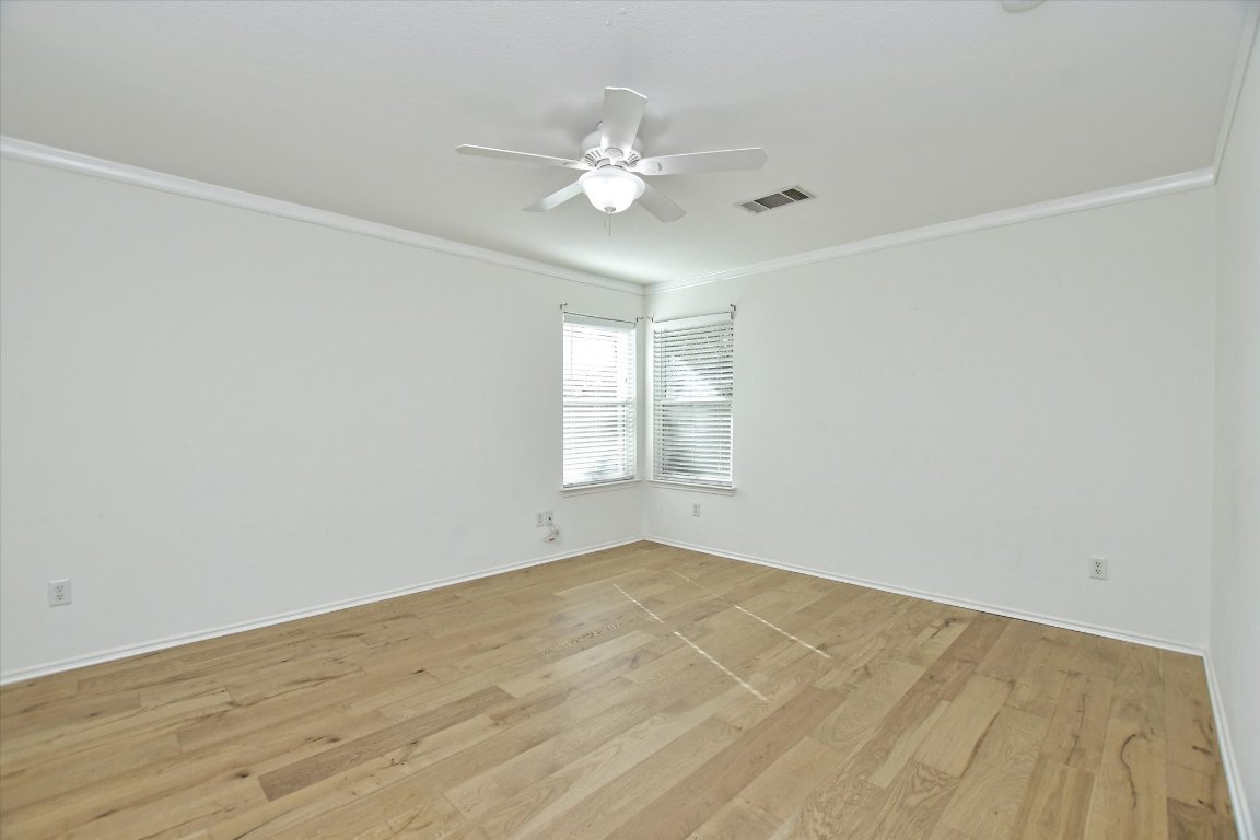 3462 Flowstone Lane Round Rock, TX 78681 - Photo 27 of 33 a view of a big room with wooden floor and chandelier fan