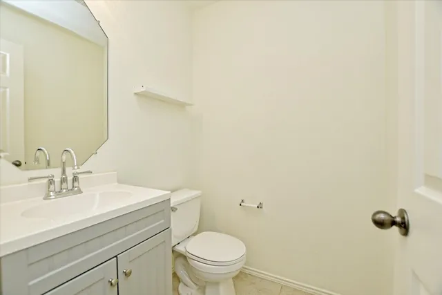 a bathroom with a sink a toilet and mirror