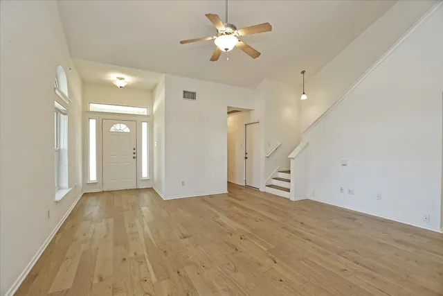 a view of empty room with wooden floor