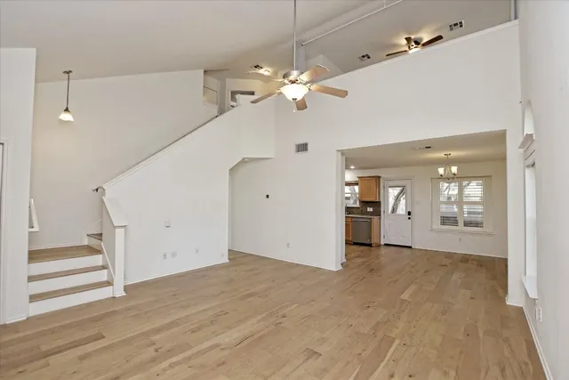 a view of a kitchen with wooden floor and a ceiling fan