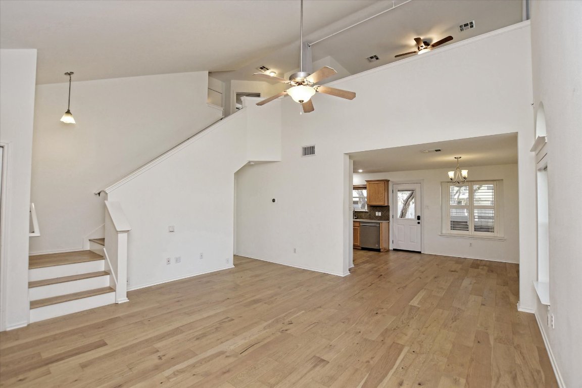 3462 Flowstone Lane Round Rock, TX 78681 - Photo 10 of 33 a view of a kitchen with wooden floor and a ceiling fan