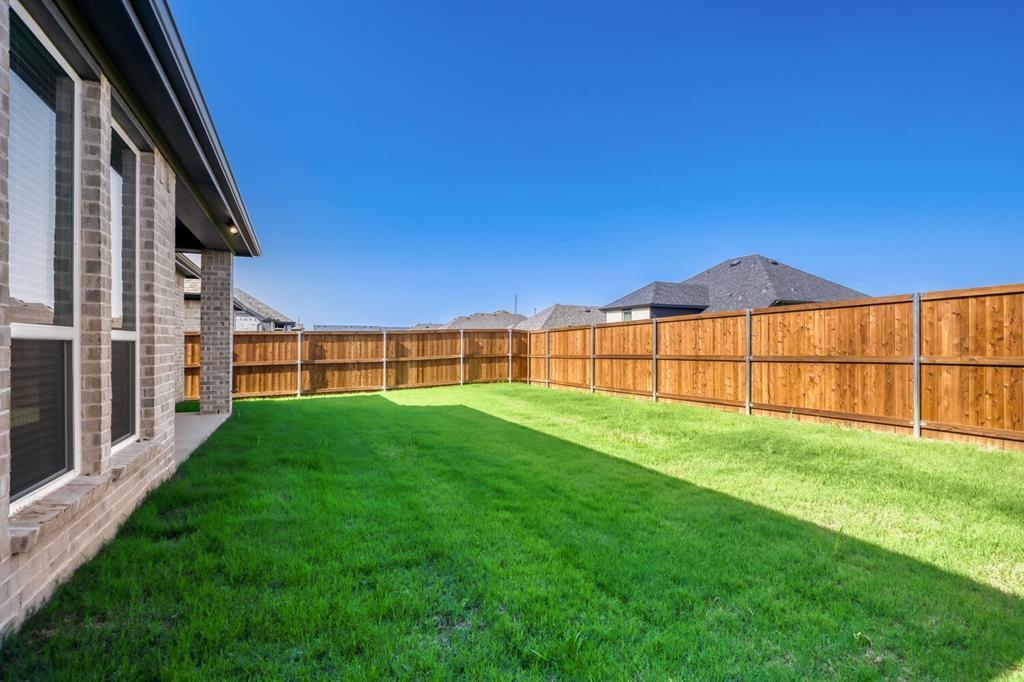 4314 Haley Way Oak Point, TX 75068 - Photo 26 of 28 Expansive backyard featuring a manicured lawn and a wooden privacy fence