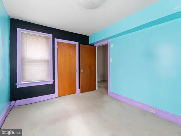 a view of an empty room and a window