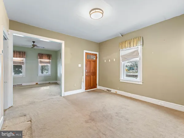 an empty room with windows and closet