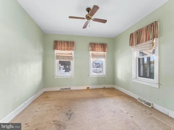 a view of a livingroom with a window and a ceiling fan