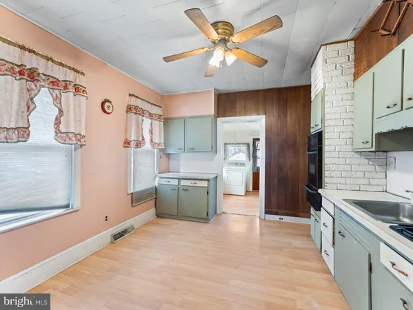 a kitchen with stainless steel appliances kitchen island granite countertop a refrigerator and a sink