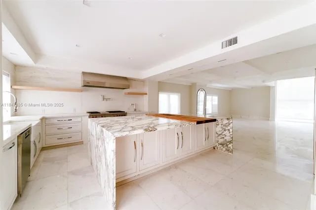 a view of an empty room with cabinet and a window