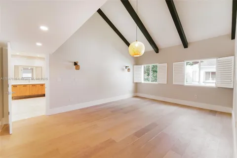 a view of an empty room with window and cabinet