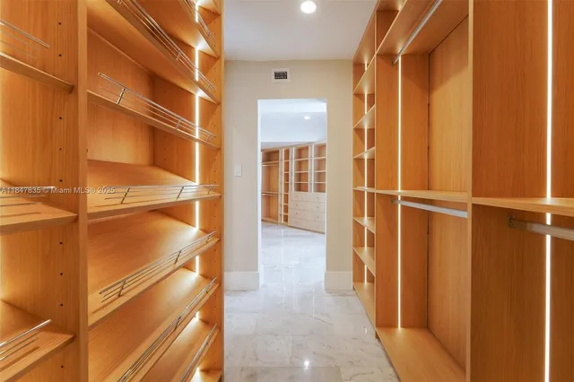 a view of a livingroom with a flesh screen tv and stairs