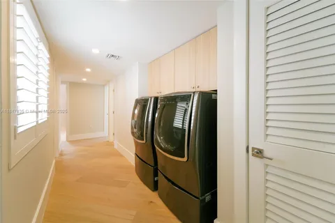a bathroom with a double vanity sink a large mirror and shower