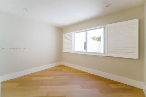 a bathroom with a toilet a sink a mirror and a shower