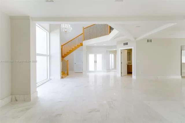 a view of empty room with floor to ceiling window