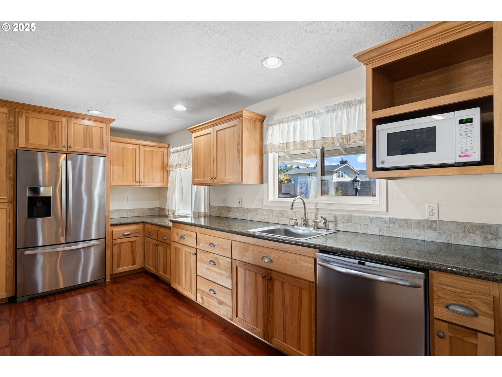 3285 Northeast 5th Street Gresham, OR 97030 - Photo 6 of 35 a kitchen with stainless steel appliances granite countertop a refrigerator sink and microwave