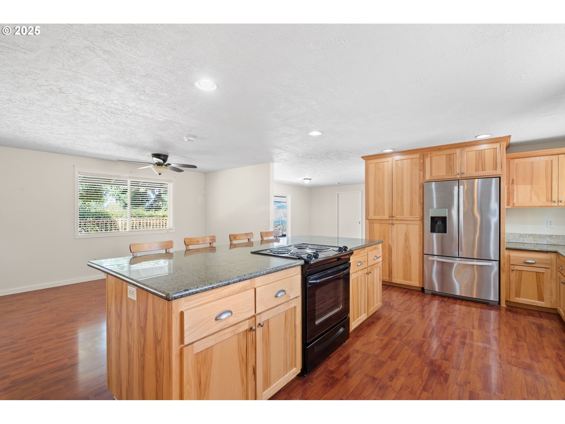 3285 Northeast 5th Street Gresham, OR 97030 - Photo 7 of 35 a kitchen with stainless steel appliances granite countertop a sink stove and refrigerator