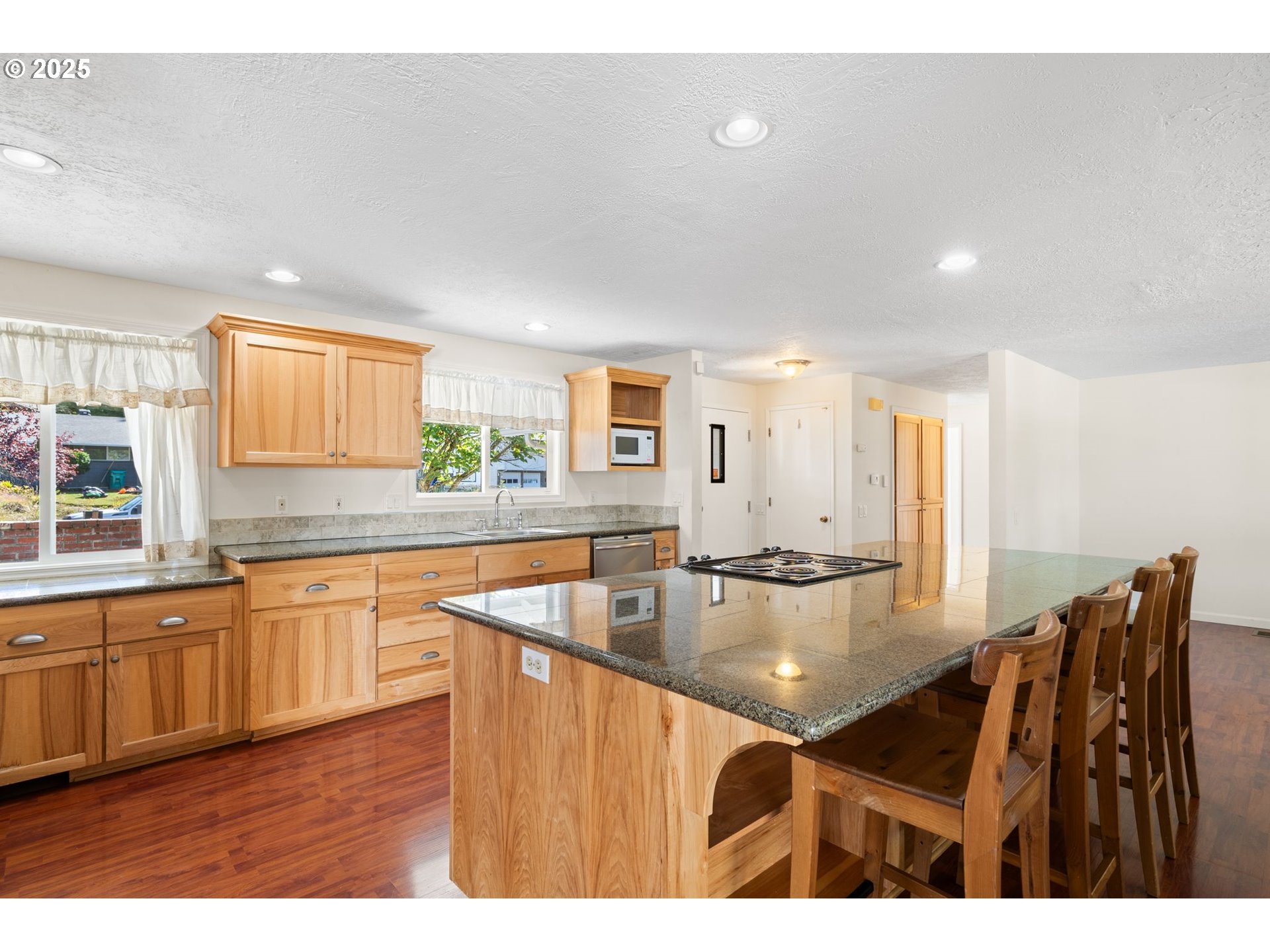 3285 Northeast 5th Street Gresham, OR 97030 - Photo 8 of 35 a kitchen with stainless steel appliances granite countertop a sink counter space and living room
