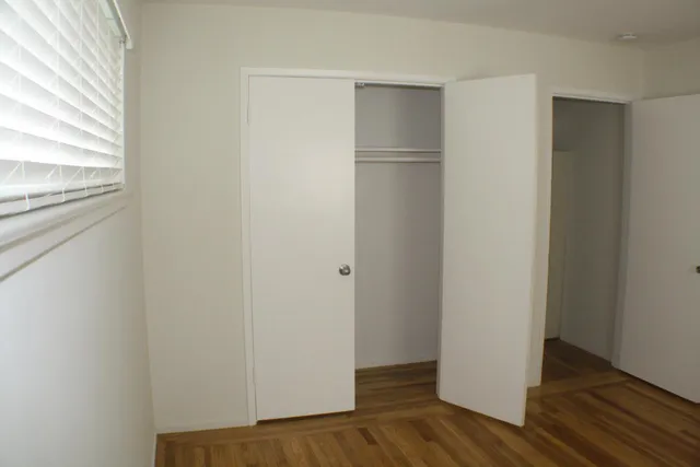 a view of walk in closet with wooden floor