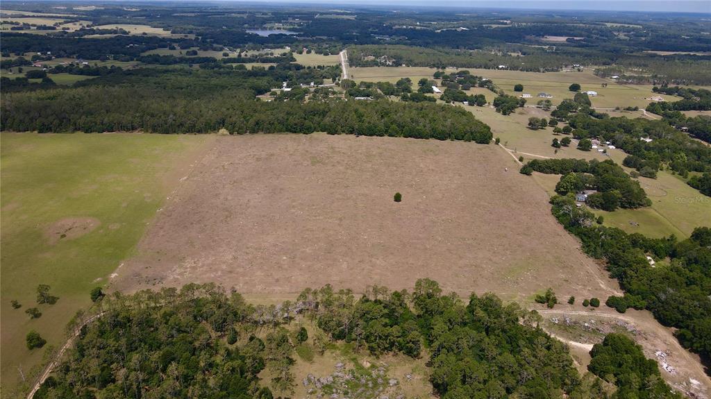 Parrish Grove Road Dade City, FL 33523 - Photo 1 of 23 an aerial view of a houses with a lake view