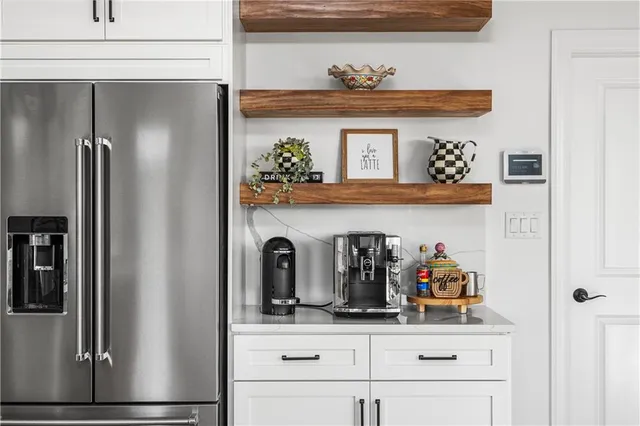 a kitchen with a refrigerator and cabinets