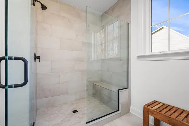 a bathroom with a glass shower door