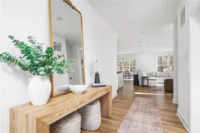 a living room with furniture and a potted plant