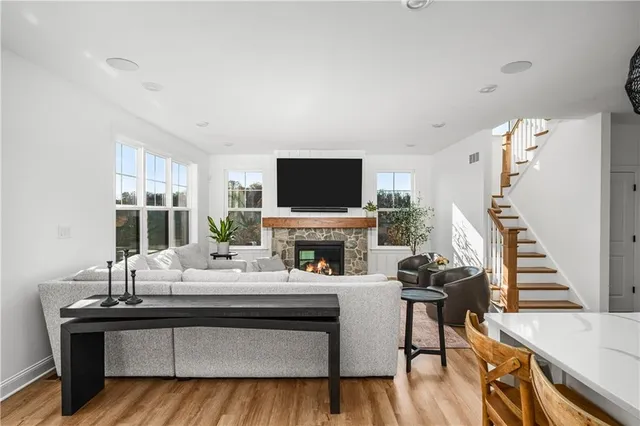 a living room with furniture a fireplace and a flat screen tv
