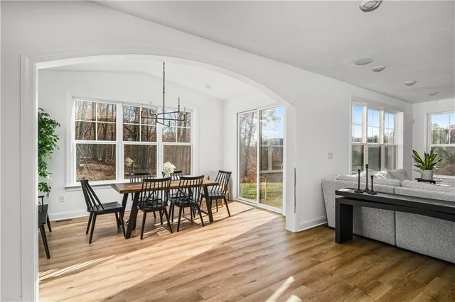 a view of a dining room with furniture and wooden floor
