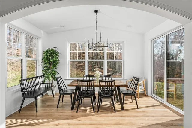 a view of a dining room with furniture window and wooden floor