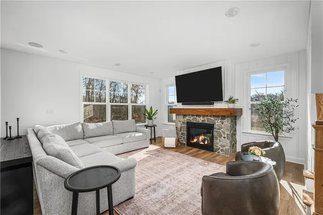 a living room with furniture a fireplace and a flat screen tv