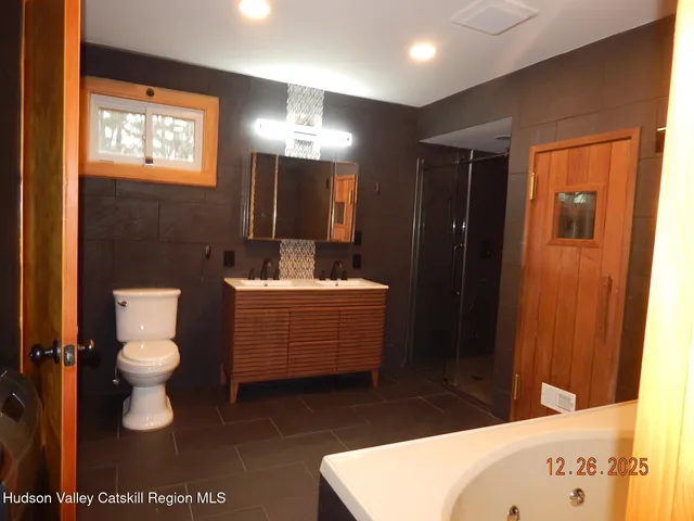 a bathroom with a bath tub and shower