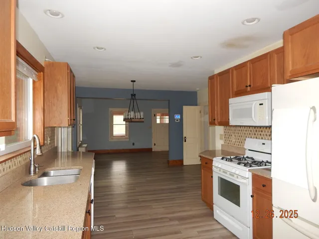 a view of kitchen with sink and wooden floor