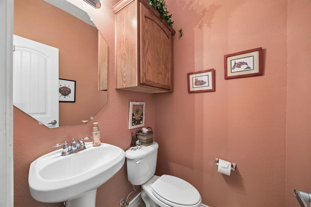 2003 Downing Street Allen, TX 75013 - Photo 33 of 40 Here is the view of the first floor half bath - Charming with pedestal sink and warm designer-inspired wall color.
