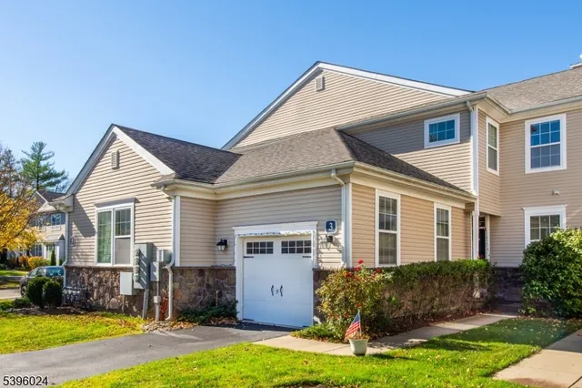 a view of a house with yard and sitting area