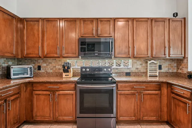 a view of a hallway with wooden floor and stairs