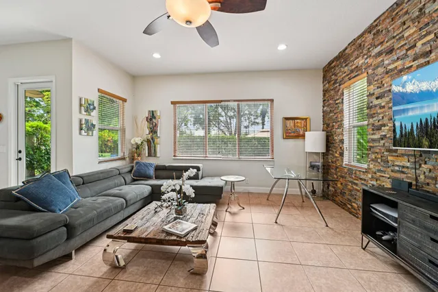 a living room with furniture and floor to ceiling windows