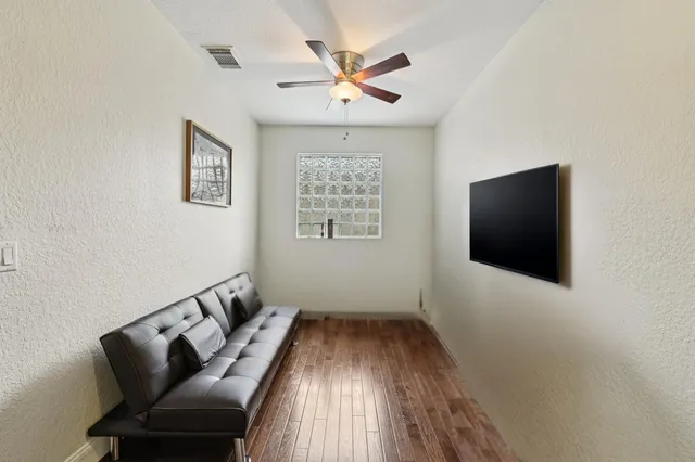a bedroom with bed and a potted plant