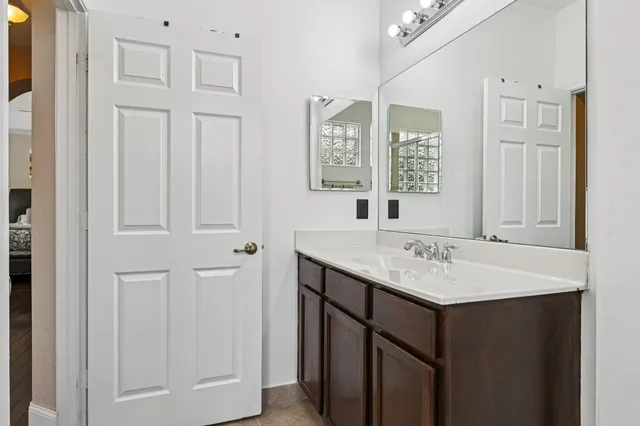 a front view of a house with a garden and plants