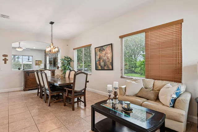 a dining room with furniture a window and wooden floor