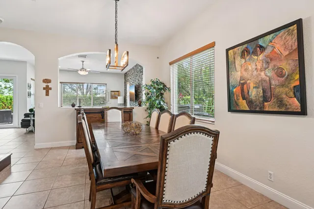 a living room with furniture a window and a dining table