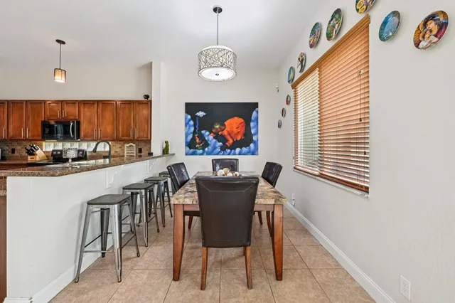 a open kitchen with stainless steel appliances granite countertop a stove top oven a sink a counter top space and cabinets