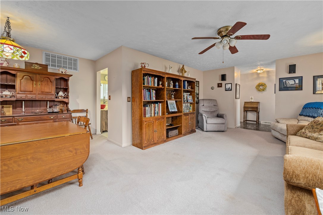 215 Sunset Road Avon Lake, OH 44012 - Photo 9 of 32 Living room featuring ceiling fan, light colored carpet, and baseboards