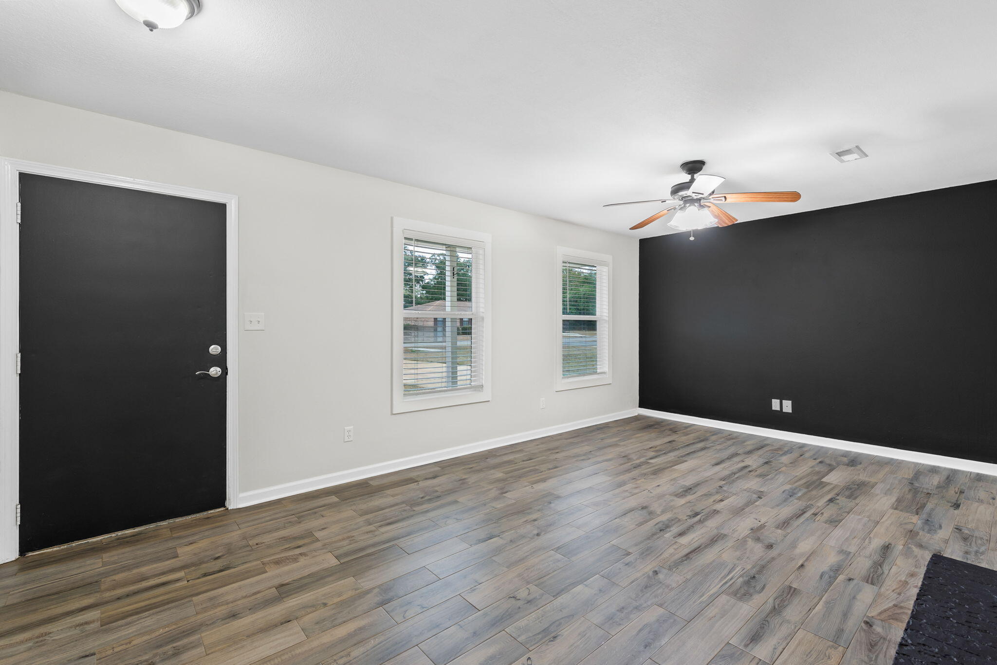 4217 North Island Road Pace, FL 32571 - Photo 5 of 25 a view of an empty room with wooden floor and a window