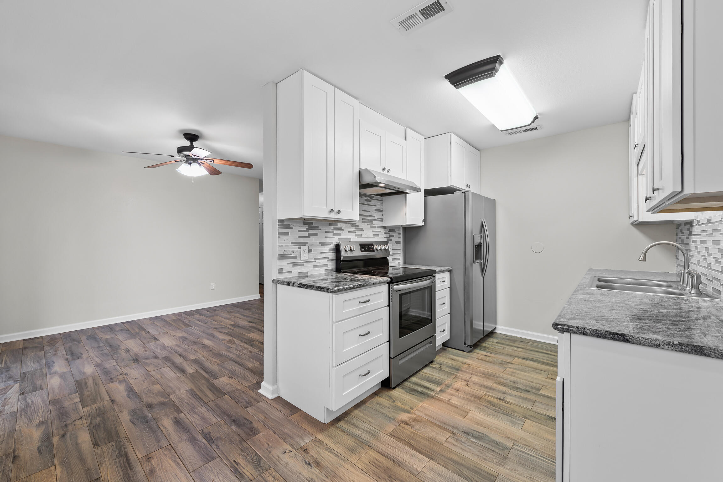 4217 North Island Road Pace, FL 32571 - Photo 8 of 25 a kitchen with a sink cabinets stainless steel appliances and a window