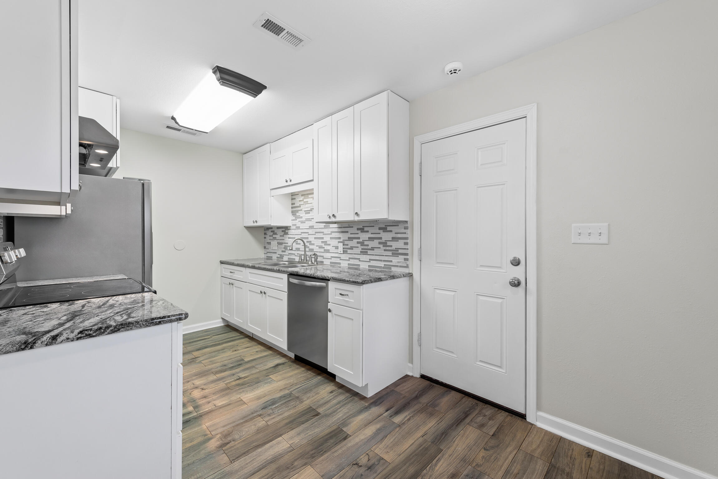 4217 North Island Road Pace, FL 32571 - Photo 9 of 25 a kitchen with a refrigerator and a stove top oven