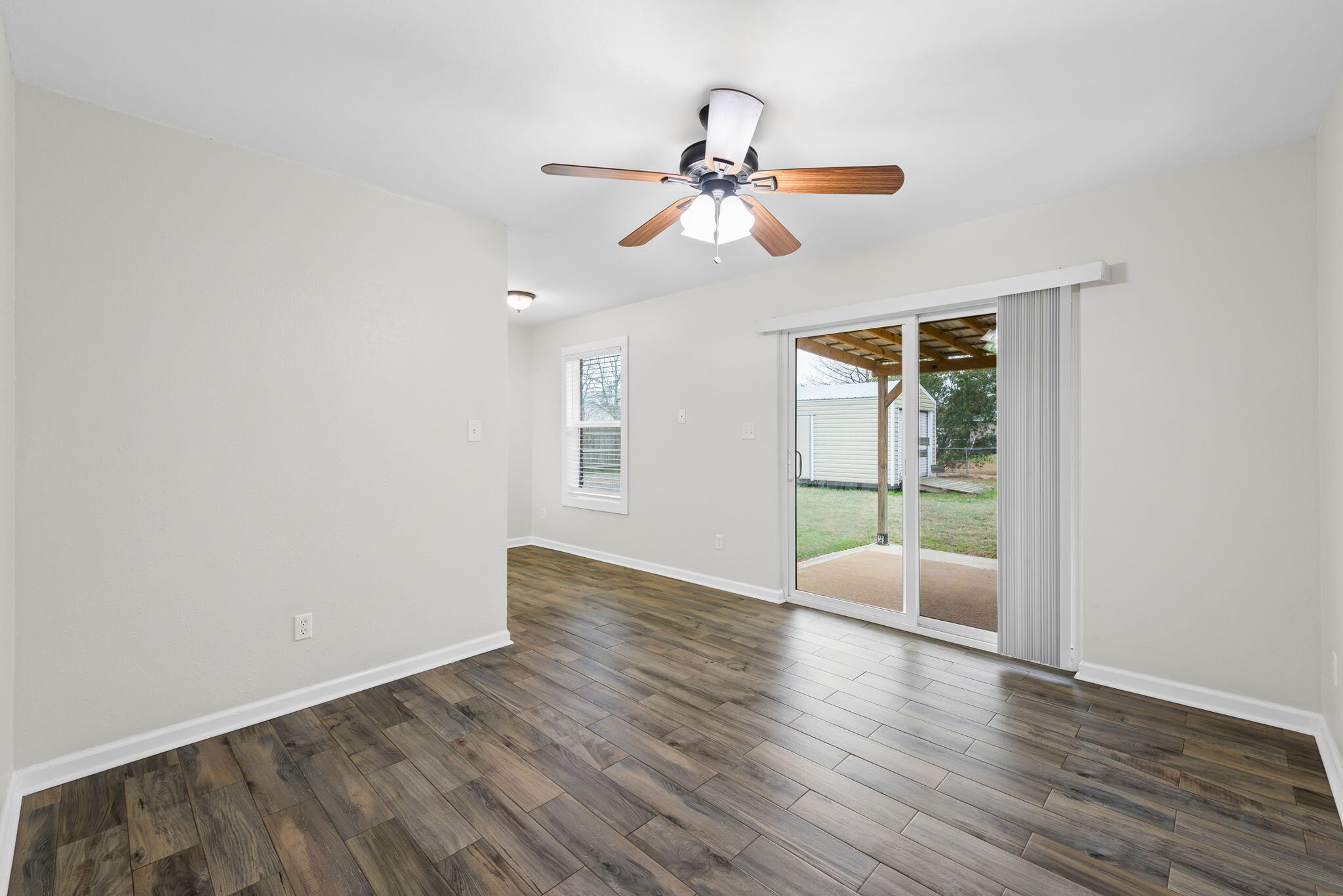 4217 North Island Road Pace, FL 32571 - Photo 10 of 25 a view of an empty room with wooden floor and a window