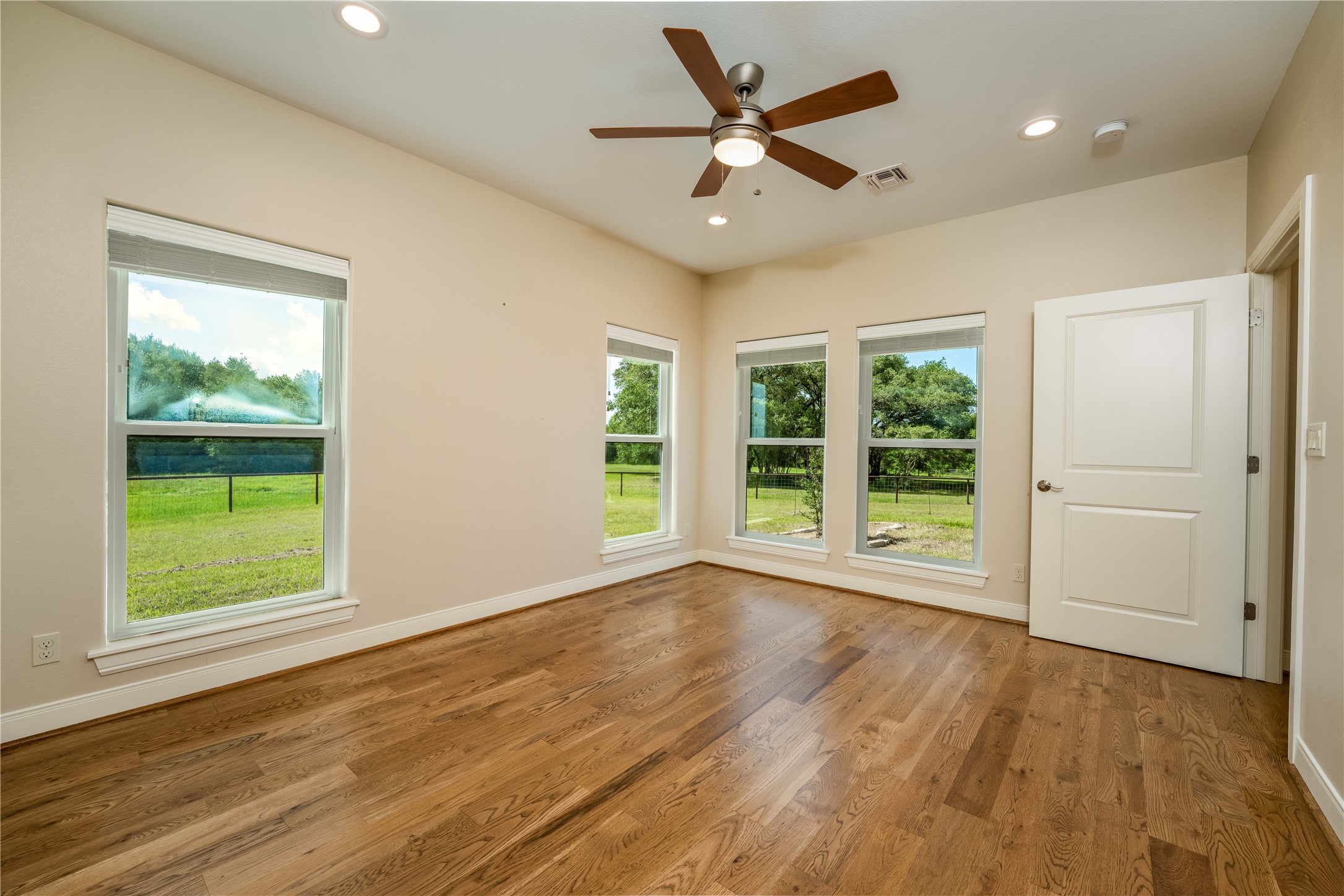 1470 South Nassau Road Round Top, TX 78954 - Photo 17 of 30 an empty room with wooden floor and windows